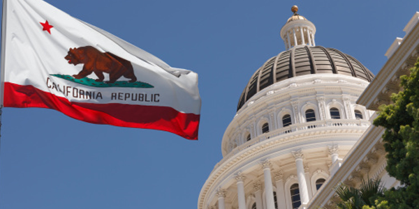 California flag flying beside the state Capitol
