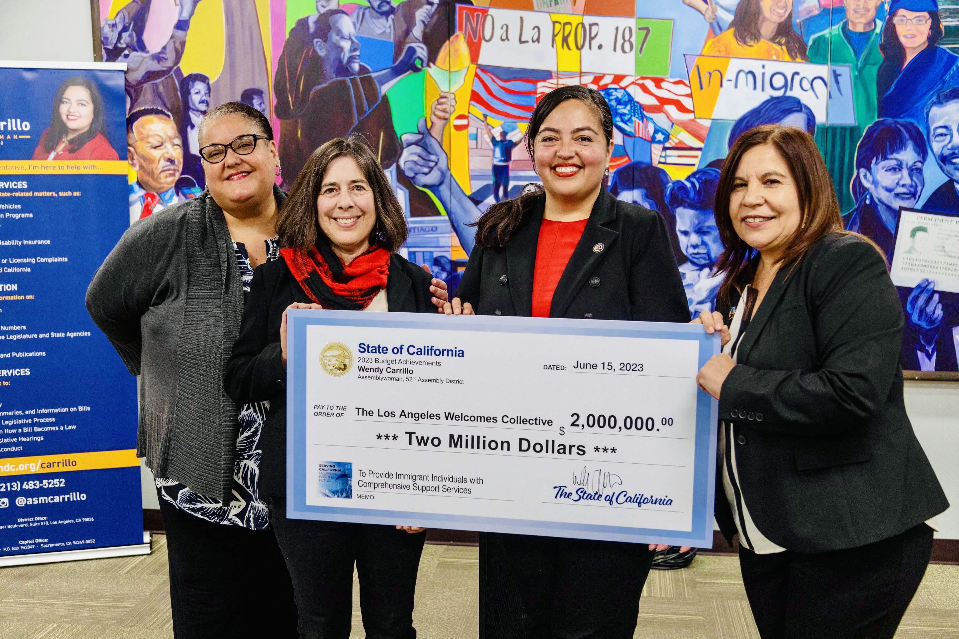 Assemblywoman Wendy Carrillo holds large symbolic check of $2million for the Los Angeles Welcomes Collective